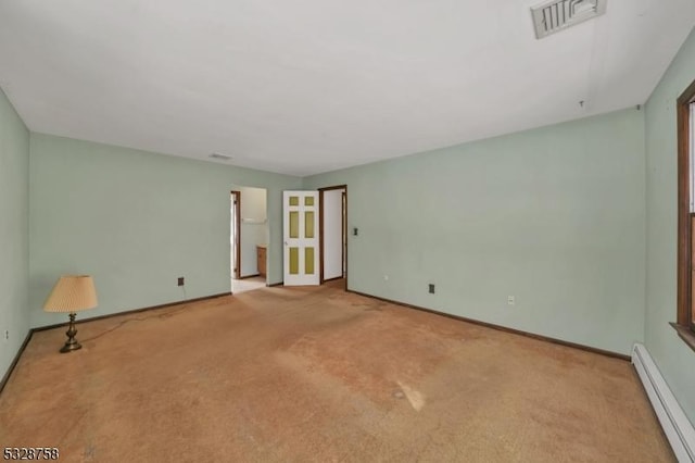 empty room with light colored carpet and baseboard heating