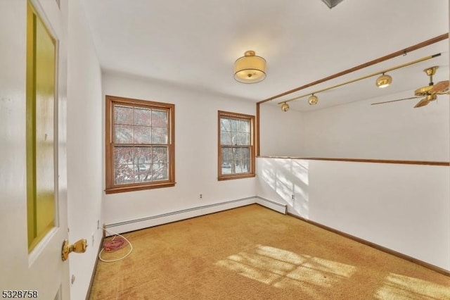 spare room featuring ceiling fan, carpet floors, and a baseboard radiator