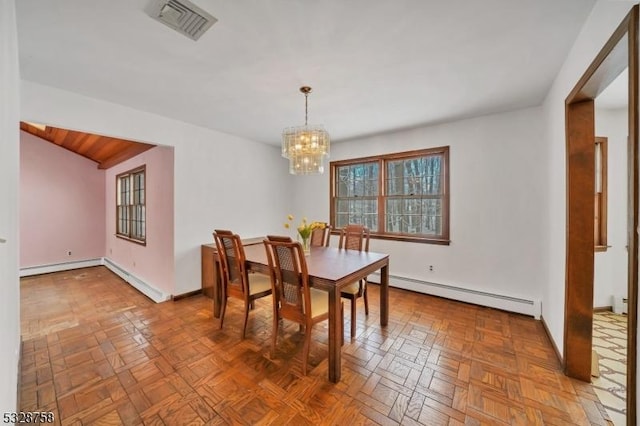 dining area with parquet floors, a baseboard radiator, and a notable chandelier