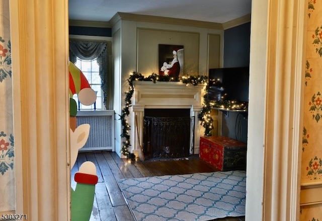 interior space featuring dark hardwood / wood-style flooring and ornamental molding