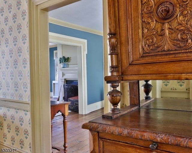 interior details with hardwood / wood-style floors and crown molding