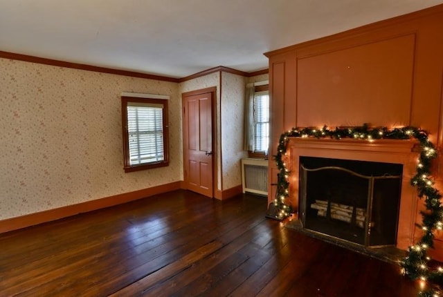 living room with dark hardwood / wood-style floors, plenty of natural light, crown molding, and radiator