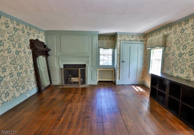 unfurnished living room with ornamental molding, dark wood-type flooring, and radiator