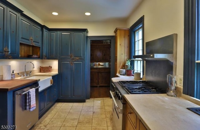 kitchen with appliances with stainless steel finishes, blue cabinets, and sink