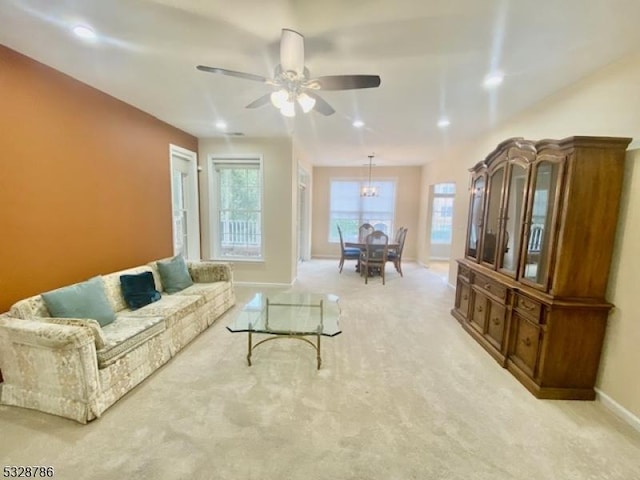 carpeted living room featuring ceiling fan