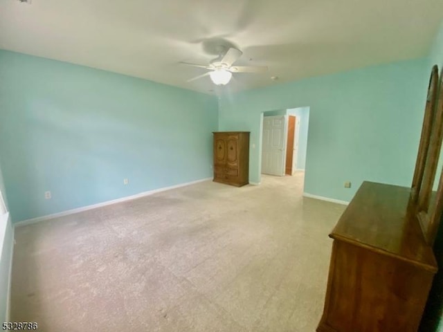 unfurnished bedroom featuring ceiling fan and light colored carpet