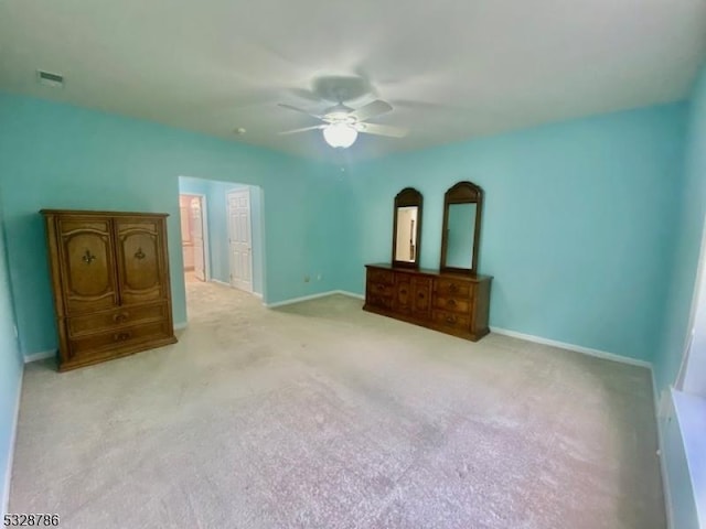 unfurnished bedroom with light colored carpet and ceiling fan