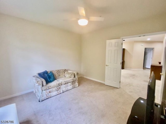 sitting room featuring light carpet and ceiling fan