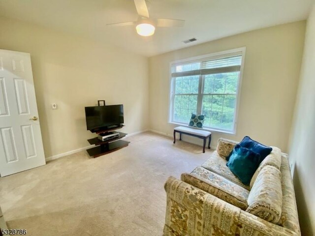 living room with carpet floors and ceiling fan