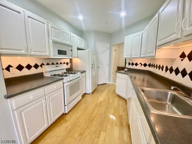 kitchen featuring white cabinets, white appliances, backsplash, and sink