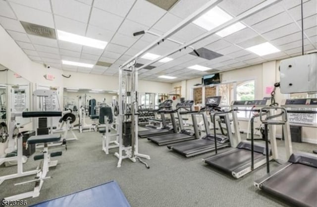 gym with a paneled ceiling