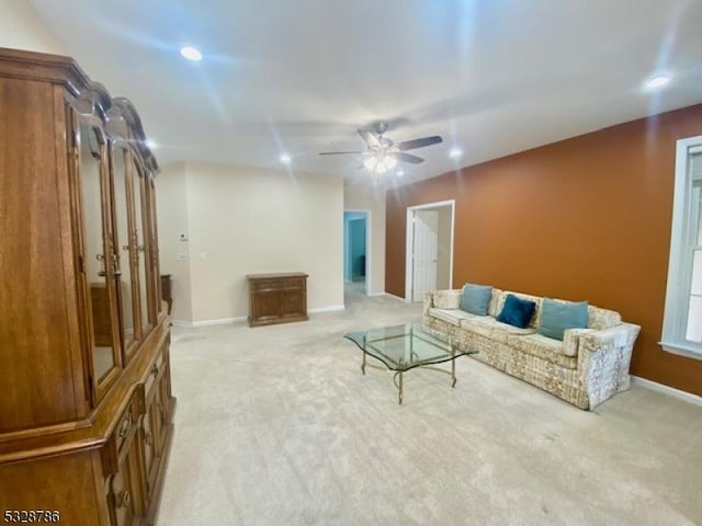 living room featuring ceiling fan and light colored carpet