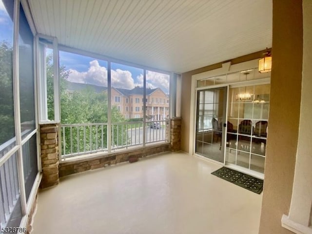 unfurnished sunroom with a wealth of natural light