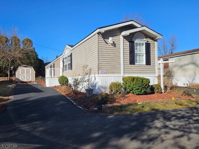 view of property exterior with a storage unit