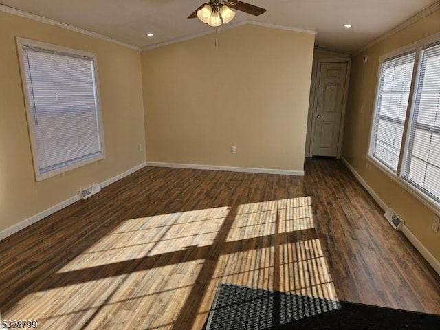 empty room featuring ceiling fan, dark hardwood / wood-style floors, vaulted ceiling, and ornamental molding