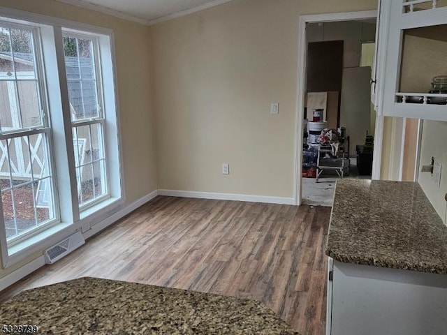 interior space featuring crown molding and wood-type flooring