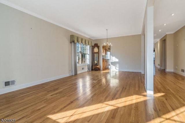 unfurnished dining area with a chandelier, wood-type flooring, and crown molding