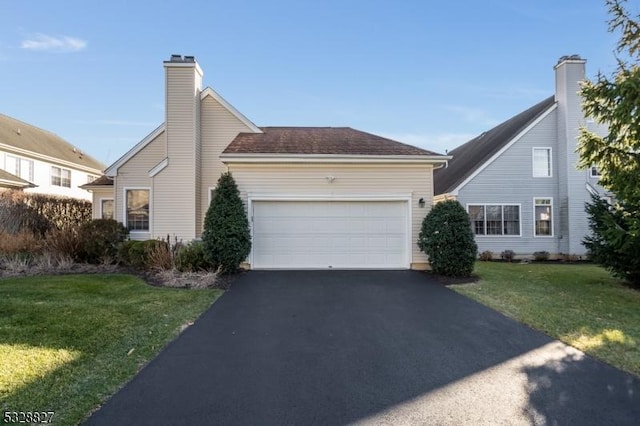 view of front facade featuring a garage and a front lawn