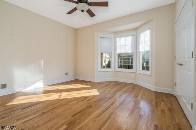 empty room featuring ceiling fan and light hardwood / wood-style floors