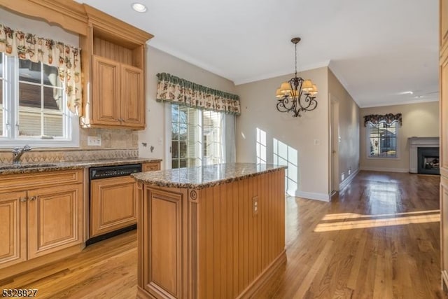 kitchen with paneled dishwasher, light wood-type flooring, pendant lighting, an inviting chandelier, and a kitchen island