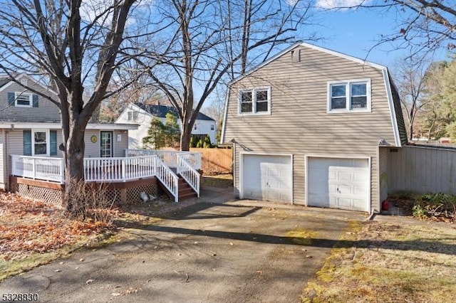 view of property exterior with a garage and a deck