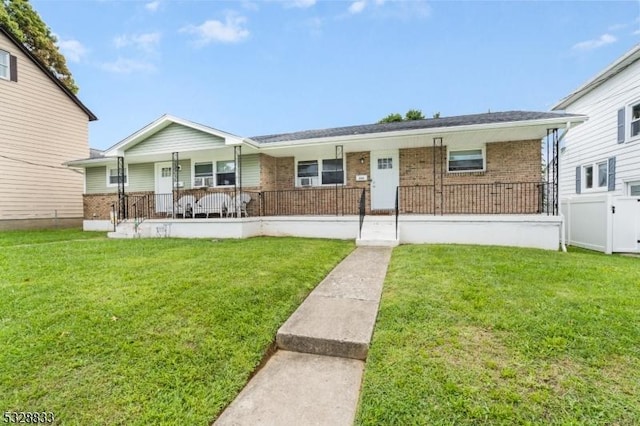 view of front of property with covered porch and a front yard