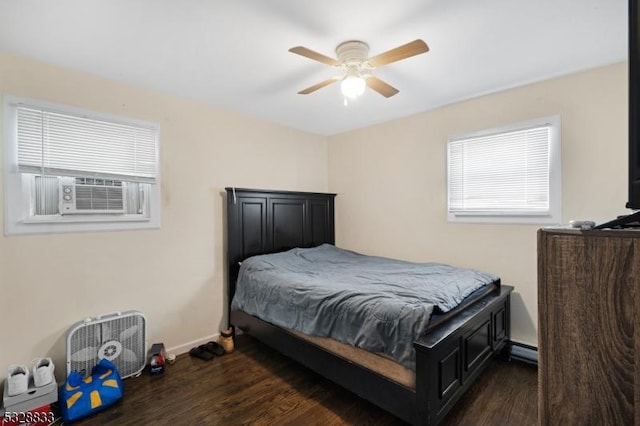 bedroom with dark hardwood / wood-style flooring, baseboard heating, ceiling fan, and cooling unit