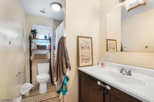 bathroom featuring tile patterned floors, walk in shower, vanity, and toilet