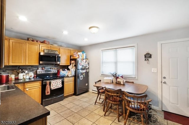 kitchen featuring black appliances, light tile patterned flooring, sink, and tasteful backsplash