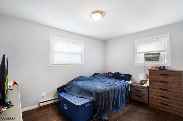 bedroom with cooling unit, a baseboard radiator, and dark hardwood / wood-style floors