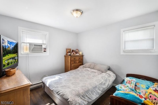 bedroom with a baseboard radiator, cooling unit, and dark wood-type flooring