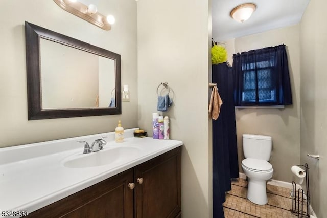 bathroom with tile patterned floors, vanity, and toilet