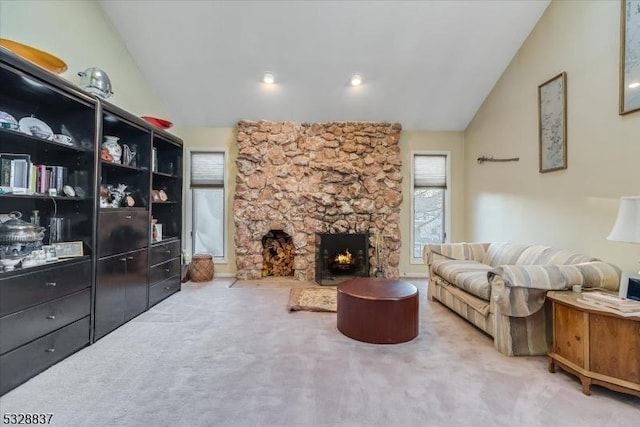 living room with lofted ceiling, a fireplace, and carpet floors