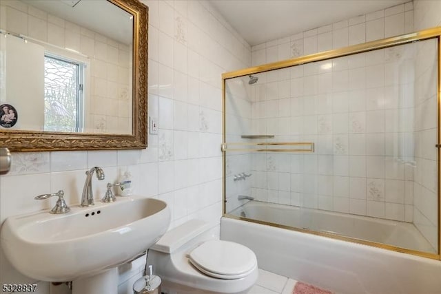 full bathroom featuring toilet, decorative backsplash, tile walls, and sink