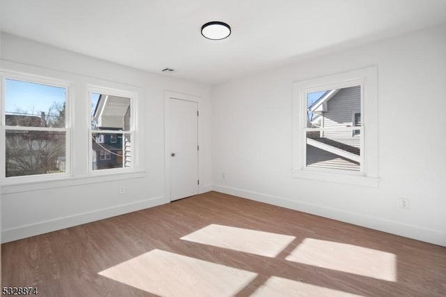 unfurnished room with hardwood / wood-style floors