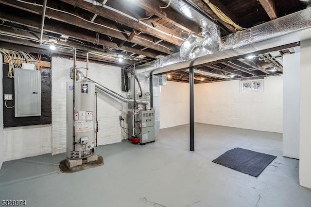 basement featuring electric panel, water heater, and heating unit