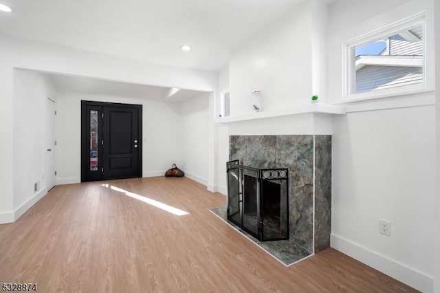 unfurnished living room featuring a fireplace and hardwood / wood-style flooring