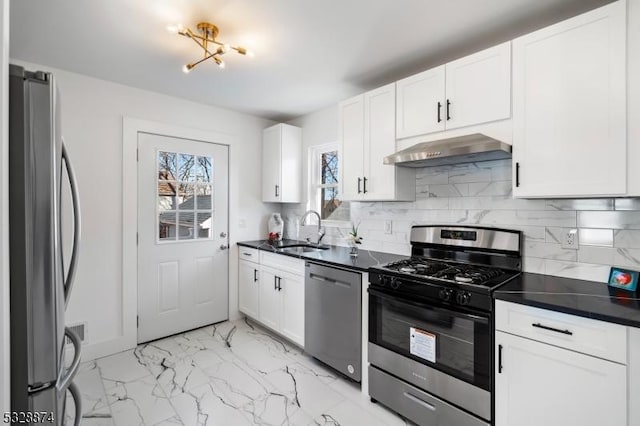 kitchen featuring sink, white cabinets, stainless steel appliances, and range hood