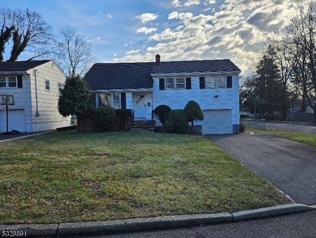 view of front of house featuring a front yard and a garage