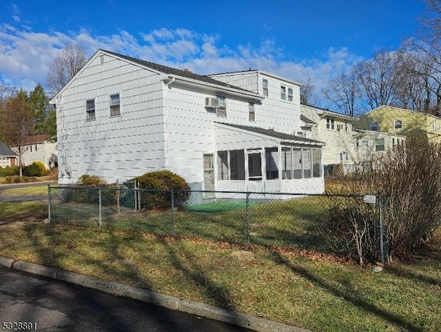 view of property exterior featuring a sunroom and a yard