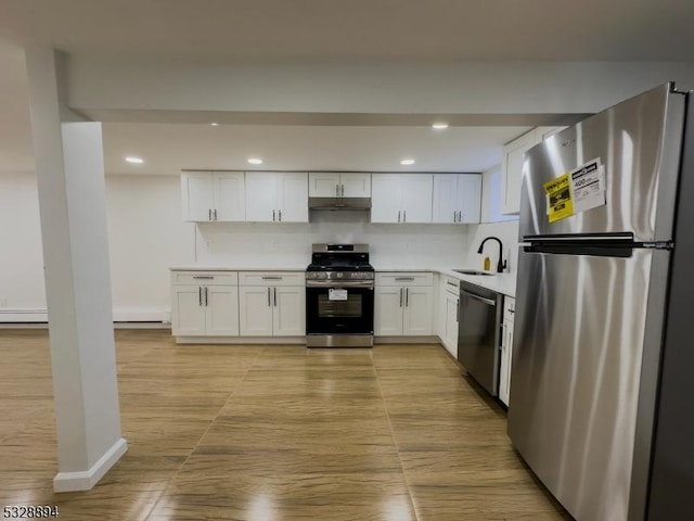 kitchen featuring decorative backsplash, white cabinetry, sink, and appliances with stainless steel finishes