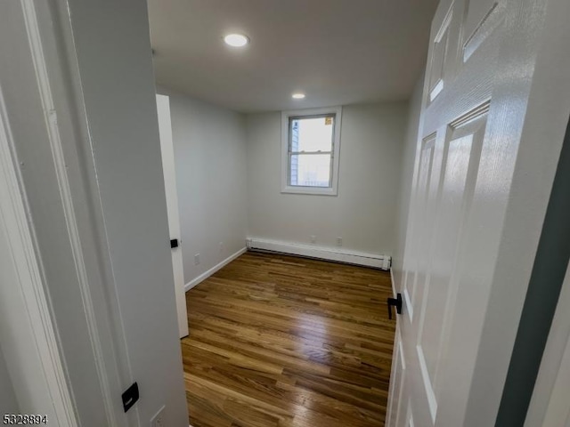 interior space featuring hardwood / wood-style flooring and a baseboard heating unit