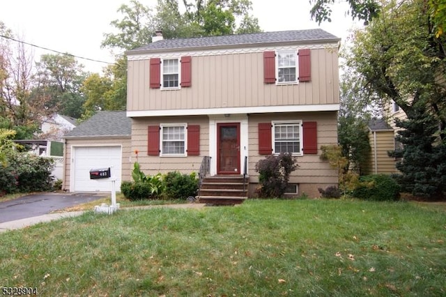 view of front of house with a front yard and a garage