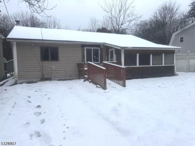 view of snow covered rear of property