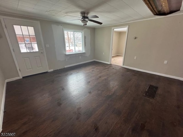 interior space with ceiling fan, crown molding, and dark wood-type flooring