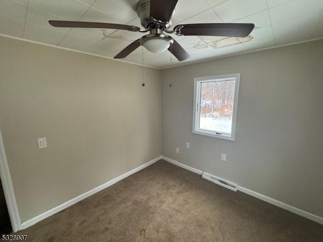 carpeted spare room featuring ceiling fan and crown molding