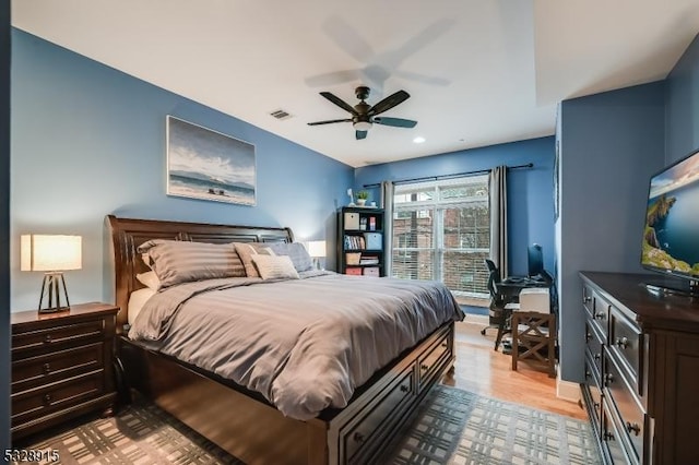 bedroom with light hardwood / wood-style flooring and ceiling fan