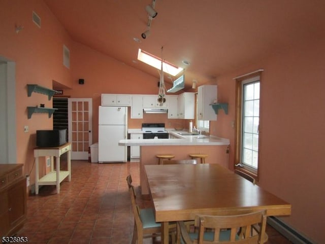 kitchen featuring white cabinets, a healthy amount of sunlight, white appliances, and kitchen peninsula