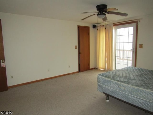 unfurnished bedroom featuring ceiling fan and carpet floors