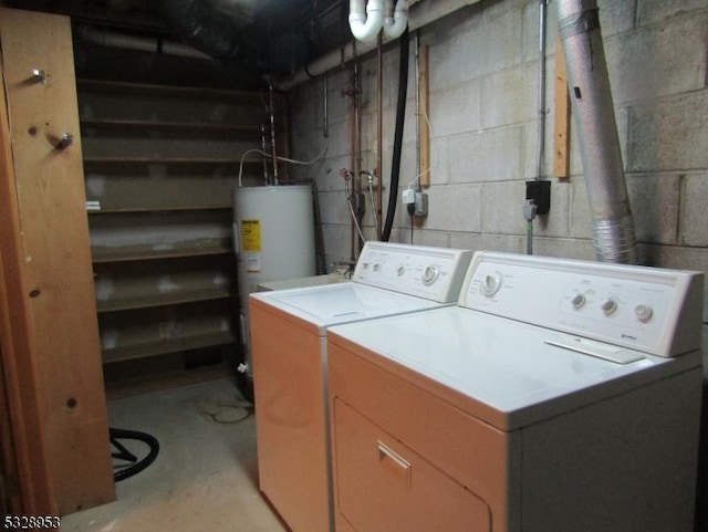 laundry area with washer and dryer and water heater